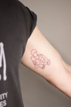 a man's arm with a small tattoo of a boy holding a teddy bear