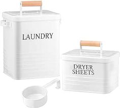 the laundry box is white and has two wooden handles on each side, along with an empty bowl