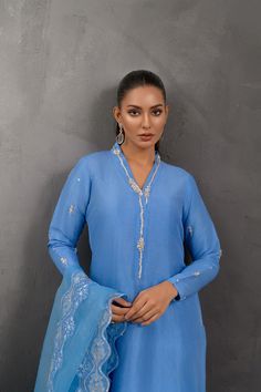 SKU: 1028 Price for Shirt and inner only.This splendid blue ensemble is fabricated on raw silk embellished with alluring sequins, pearls and French knots work giving this piece a perfect oomph. Paired with a gorgeous dupatta adorned with floral work. Blue Raw Silk Sharara For Party, Blue Raw Silk Sets With Mirror Work, Blue Raw Silk Sharara With Mirror Work, Blue Raw Silk Traditional Wear With Mirror Work, Blue Raw Silk Party Sets, Blue Raw Silk Dupatta With Mirror Work, Blue Chinon Kurta For Wedding, Blue Raw Silk Palazzo Set With Mirror Work, Elegant Sharara With Mirror Work In Slub Silk