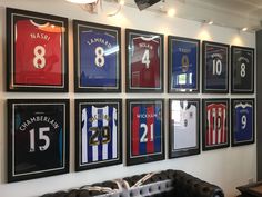 a wall with framed soccer jerseys on it