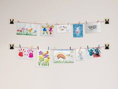 several children's handprints are hung on a clothes line