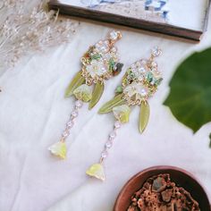 ⭐️ Introducing our stunning botanical-style earrings, featuring intricate designs of delicate Lily of the Valley flowers. Each flower petal is meticulously crafted to showcase the intricate details of this beautiful flower. ⭐️ Handcrafted with exceptional attention to detail, these earrings are a true work of art. The green color of the design adds a touch of spring to any outfit, while the simple dangles allow the botanical design to be the star of the show. ⭐️ These earrings are versatile and easy to style, making them a perfect addition to any jewelry collection. Whether you're dressing up a casual outfit or adding the finishing touch to a formal dress, these earrings will add a touch of elegance to any ensemble. 🎁 Our botanical-style earrings also make a great gift for any occasion. T Spring Wedding Drop Earrings, Elegant Spring Chandelier Earrings, Spring Wedding Dangle Earrings, Spring Wedding Dangle Flower Earrings, Spring Wedding Flower Charm Earrings, Elegant Spring Jewelry With Birth Flower Details, Elegant Spring Birth Flower Jewelry, Beaded Dangle Flower Earrings For Wedding, Elegant Beaded Flower Earrings For Spring