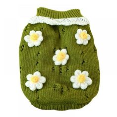 a green knitted dog sweater with white and yellow flowers