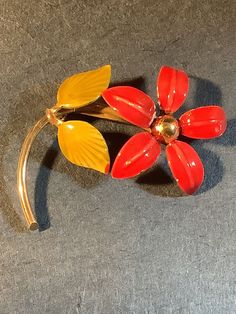 Vintage gold tone enamel flower brooch. Red and yellow enamel flower 2 x 1.25 inches Brooch enamel has home wear on the edges and near the center. Single rivet on the flower back and not signed. Firm lock pin clasp.   (D569) Red Enamel Brooch, Red Enamel Brooch Pin, Vintage Red Enamel Brooches, Red Enamel Vintage Brooch, Collectible Gold Flower Enamel Pin, Yellow Enamel Brooches For Gifts, Retro Enamel Brooch Pins, Vintage Enamel Flower Brooches, Floral Enamel Brooch Pin