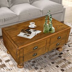 a coffee table sitting on top of a rug next to a couch