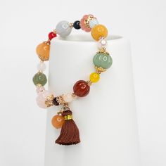 ⚜Item Specifics❀ Natural Gemstone Pumpkins: Yellow Jade, Aventurine, Rose Quartz, Hetian Jade (10-12mm);❀ Natural Gemstones: Pearl, Rose Quartz, Obsidian, Jade❀ Gold Plated Bead Cap;❀ Silk Tassel;❀ Length: 17cm Pumpkin (南瓜; nánguā) is symbol of prosperity, abundance, descendant's luck, illustrious children, and enchantment in Chinese culture. It is a wonderful auspicious gift especially in autumn season. Multicolor Jade Round Beads Crystal Bracelet, Multicolor Jade Beaded Crystal Bracelet, Multicolor Jade Bead Crystal Bracelet, Multicolor Jade Crystal Bracelet With Round Beads, Pumpkin Bracelet, Chinese Meditation, Asian Jewelry, Yellow Jade, Pearl Rose