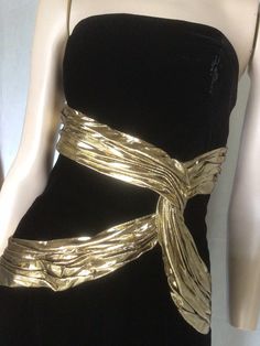 "Vtg 80s A J Bari black and gold Velvet sleeveless Cocktail Dress 8 Preowned. Condition 10/10. No issues to note.  Style A straight form fitting knee length dress,  the bodice is boned for structure and support. Gold lame ribbon swaiths across the bodice give further definition and a unique aspect to this dress. Suitable for any formal, social event, this dress would be a valuable go to in any fashion fashionista wardrobe. Easy to style Fully lined Fastens with a centred rear zip. 7.5\" Front centre kick pleat.  Clipped to the mannequin. Size to fit Australian 10 Go by measurements below garment laid flat Underarm to underarm. 17\". 43cm Waist. 14\". 35.5cm Hips. 18.5\". 47cm Length from underarm. 32\". 81cm Be unique, wear vintage. My photos form an important part of the product descripti Gold Dress Aesthetic, 80’s Dresses, Gold Glitter Dress, Clawdeen Wolf, Velvet Party Dress, Gold And Black Dress, Golden Dress, Velvet Cocktail Dress, Gold Lame