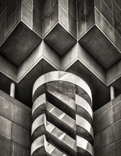 an architectural building with geometric designs on the front and sides, in black and white