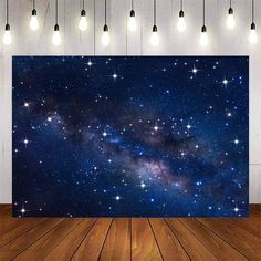 a room with wooden floors and a large wall mural that has stars in the sky