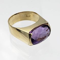 "Cool and contemporary, this vintage 18K gold ring rules! The European made ring combines a neat shape with an stunning amethyst gemstone that is horizontally set. Sleek and minimal, the jeweler who handcrafted this piece did a great job economizing on the gold...it is surprisingly lightweight. Vintage: Late 1960s - Early 1970s Size: 6 1/4 note that wider bands mean tighter fits Materials: 18K Yellow Gold, Amethyst Marked: 750, scrolly M maker's mark Amethyst: modified cushion cut oval, medium d Ladies Silver Rings, Amethyst Ring Vintage, Vintage Modern Style, Fine Gold Jewelry, Carnelian Ring, Late 1960s, Cameo Necklace, Purple Band, 18k Gold Ring