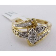 Carat: 10k Yellow Gold (Not Plated Or Overlaid) Gemstones: 23 Genuine Diamonds Total Weight - 1 Carat Diamond Grades, Clarity Grade . . . Si2 Color Grade . . . K Shape: Baguette & Round Type Of Setting: Channel Net Weight: 4.82 Grams Ring Size: 7.25 (Free Resizing Service - If Needed) Collectible Yellow Gold Rings With Diamond Accents, Collectible Diamond Ring With Diamond Accents, White Hallmarked Diamond Ring Collectible, Hallmarked Yellow Gold Marquise Diamond Ring, Classic Hallmarked Marquise Diamond Ring, Vintage Baguette Cut Diamond Accented Jewelry, Marquise Diamond Ring Hallmarked For Anniversary, Marquise Diamond Ring For Anniversary (hallmarked), Hallmarked Marquise Ring For Anniversary