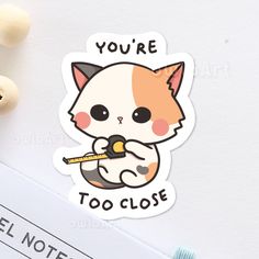 a sticker that says you're too close with a cat holding a pencil