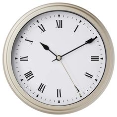 a white clock with roman numerals on the face is shown against a white background