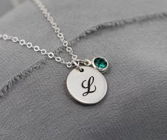 "Classic and charming, this personalized, Sterling Silver necklace will be a gift she treasures for years to come. Featuring: ♥ a smooth, Sterling Silver 1/2\" disc (13mm), engraved with the cursive initial of your choice ♥ a sparkling Swarovski crystal birthstone of your choice, set in Sterling Silver (6mm including setting) ♥ hung on sparkling Sterling Silver chain in your choice of lengths ♥ packaged in a box with floral band, ready for gift giving ♥ add additional charms from my shop to cust Silver Birthstone Initial Pendant Jewelry, Engraved Sterling Silver Birthstone Necklace With Initial Pendant, Silver Initial Necklace With Birthstone For Gift, Silver Initial Pendant Birthstone Necklace For Personalized Gift, Mother's Day Heart-shaped Sterling Silver Initial Necklace, February Birthstone Necklace, Birthday Presents For Mom, Letter Jewelry, Sterling Silver Initial