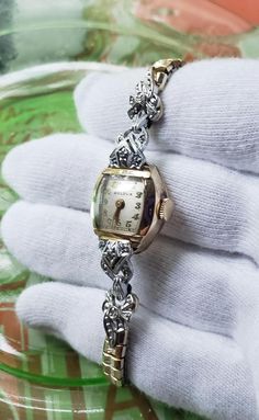 This is a rare, absolutely spectacular, Art Deco white and yellow gold filled 1930's, with 8 diamonds, Bulova women's mechanical watch. What a gorgeous piece of jewelry! There is a white gold and diamonds extended bezel set in yellow gold! Absolutely beautiful! This wonderful dainty watch is in amazing condition,  showing how much it was cherished and loved.  It works well. Please see photos as they speak wonderfully to the beauty and condition of this special bracelet! What a rare, spectacular, Gold Art Deco Wedding Watch, Art Deco Gold Jewelry And Watches For Anniversary, Collectible Gold Art Deco Jewelry And Watches, Gold Art Deco Diamond Watch For Anniversary, Gold Art Deco Watch For Anniversary, Gold Art Deco Anniversary Watch, Dainty Watch, 1930s Art Deco, Mechanical Watch