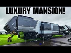 an rv park with many different types of recreational vehicles parked on the grass and one is advertising luxury mansion