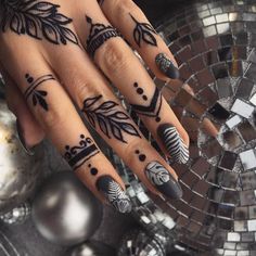 a woman's hand with black and white designs on it