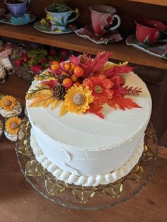 there is a white cake with flowers on it