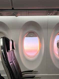 an airplane with two seats facing the window and another seat sitting in front of it