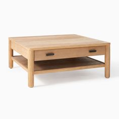 a wooden coffee table with two drawers on each side and an open shelf underneath it