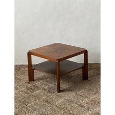 a square wooden table sitting on top of a carpeted floor