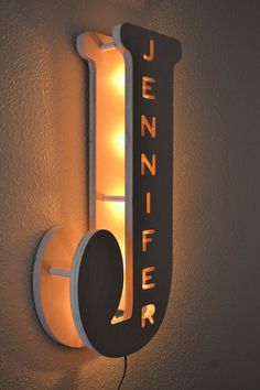 a light that is on the wall next to a sign with letters and lights in it