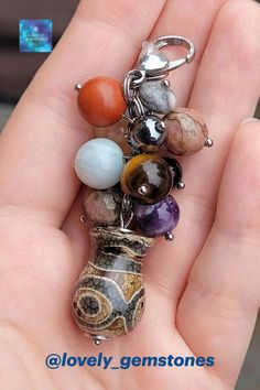 This unisex keychain, was created with: 3 eyed Vase Dzi agate, amethyst, red jasper, tiger eye, black obsidian, picture jasper, citrine, rhodonite, aquamarine, amazonite, serpentine, clear quartz and hematite beads. • Please follow us on IG @lovely_gemstones • keychain, amulet keychain, talisman keychain, gemstone keychain, crystal keychain, natural stone keychain, key clip, dzi 3 eyed vase, dzi keychain, dzi bead, dzi agate, green dzi vase, wealth, prosperity, good luck, good health Red Jasper Jewelry, Red Stone Bracelet, Red Stone Earrings, Month Gemstones, Red Jasper Bracelet, Red Stone Necklace, Birthday Gemstones, Crystal Keychain