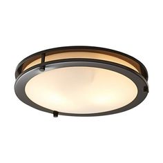 a ceiling light that is on top of a white wall and has a black frame around it