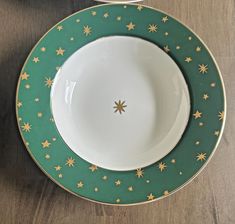 two green and white plates with gold stars on them