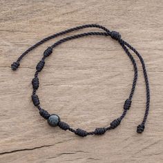 Rugged meets beautiful in this pendant bracelet designed by Ruben and Gilda Perez of Guatemala. A single bead of captivating black jade is centered on black nylon cord with evenly spaced cylindrical knots. The bracelet is easy to put on and fit to size thanks to a sliding knot closure. Black Necklace With Adjustable Cord For Meditation, Black Beaded Bracelet With Sliding Knot, Adjustable Spiritual Obsidian Jewelry, Spiritual Hand-strung Jewelry In Waxed Cord, Adjustable Black Hand-strung Braided Bracelet, Black Bohemian Bracelet With Waxed Cord, Black Adjustable Braided Bracelets With Round Beads, Adjustable Black Braided Bracelet With Round Beads, Bohemian Black Jewelry With Sliding Knot