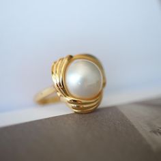 Natural Mabe Pearl Ring With s925 Sterling Silver|Vintage Pearl Jewelry|Statement Pearl Ring silver|Everyday Real Pearl ring\gift for mom 💚💚 Specifics: 💚Materials: Natural Mabe Pearl With 24k gold plated s925 silver 💚Size: 17mm*17mm 💚Closure: the closure is made of 925 sterling silver.  💚Metal: Gold plated s925 silver 💚Handmade Artwork, original design and copyright protected💚 💚The ring size is adjustable, ensuring a comfortable fit for various finger sizes. You can easily customize it Vintage Pearl Jewelry, Mabe Pearl, Vintage Pearl, Jewelry Statement, Handmade Artwork, Real Pearls, Vintage Pearls, Gold Plated Silver, Ring Silver