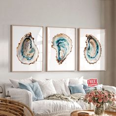 three paintings on the wall in a living room