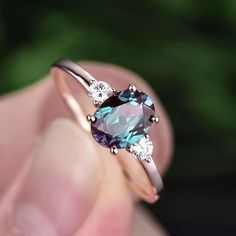 This is a 1.3 carat lab treated alexandrite engagement ring in solid gold,about 6x8mm oval cut. The accent stones are moissanites,forever classic quality. It can be made in any ring size. However please contact me to custom make it to a special big or small size. It can be made in white gold,rose gold or yellow gold wi Rose Gold Oval Engagement Ring, June Birthstone Ring, Birthday Gift Ring, Agate Engagement Ring, Engagement Ring Rose Gold, Alexandrite Engagement Ring, Art Deco Diamond Rings, Alexandrite Ring, Birthday Ring