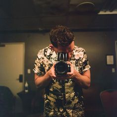 a man taking a photo in front of a mirror