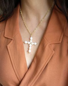 A delicate symbol with subtle shine, the Cross Pendant Necklace in Freshwater Pearls is a meaningful reminder of what matters to you most. Celebrating all forms of beauty. Wear it as a stand-alone piece or pair it with any of our necllaces to create an statement look. Details: A+ Quality pearls carefully hand selected. Pendant: Hand forged Secured with a 14k gold clasp. Adjustable length up to 24" Sustainable and natural materials Ships with eco-friendly package, brand charm and jewelry bag Cross Pendant Pearl Chain Necklace As Gift, Gift Pearl Charm Cross Pendant Necklace, Elegant Pearl Pendant Cross Necklace As Gift, Elegant Hypoallergenic Cross Pendant Jewelry, Pearl Charm Cross Necklace For Gift, Cross Necklace With Pearl Charm For Gifts, Cross Necklace With Pearl Charm As Gift, Elegant Cross Pearl Necklace For Gift, Elegant Cross-shaped Pearl Necklace For Gifts