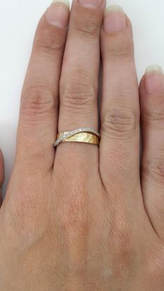 a woman's hand with a gold ring on it