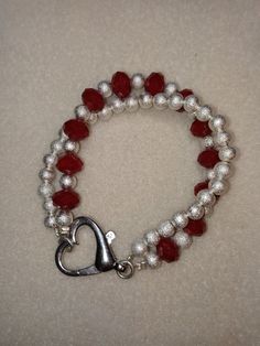 Silver and red bracelet with heart clasp Red Bracelets With Heart Beads, Red Heart Bracelet For Valentine's Day Anniversary, Red Heart Bracelets For Anniversary, Red Heart Bracelet For Anniversary, Red Heart-shaped Bracelets For Valentine's Day, Red Heart-shaped Anniversary Bracelets, Red Heart-shaped Anniversary Bracelet, Red Bracelets With Heart Charm For Anniversary, Red Heart Bracelet For Party