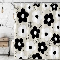 a shower curtain with black and white flowers on it