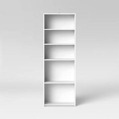 an empty white bookcase on a plain surface with no one in the room to read