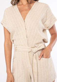 A classic short-sleeve bohemian short romper in a neutral stripe. Linen stripe Short cuffed sleeve Surplice v-neckline Concealed snap button-front top Button front shorts Hook & bar closure at the waist Half-elastic waist at the back Adjustable tie waist Side pockets Short romper Ready to romp? Our classic short romper is designed in a soft neutral stripe. Featuring short cuffed sleeves, an adjustable tie waist belt, and essential side pockets. We love to pair this Summer style with a lace-up sa Striped Short Sleeve Jumpsuits And Rompers For Beach, Striped Short Sleeve Jumpsuits And Rompers For Summer, Beige Short Sleeve Jumpsuits And Rompers For Vacation, Beach Short Sleeve Jumpsuits And Rompers With Button Closure, Beach-ready Short Sleeve Jumpsuits With Button Closure, Short Romper, Boho Romper, Cuffed Sleeve, Button Front Top