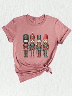 **Nutcrackers Shirt - Spread Holiday Cheer in Style!** Get ready to embrace the holiday spirit with our delightful **Nutcrackers Shirt**! This cute Christmas tee is perfect for family gatherings, festive parties, or simply lounging at home while sipping hot cocoa. Made from a soft and breathable cotton blend, this shirt ensures maximum comfort, so you can enjoy all your holiday activities without a hitch. Available in a variety of sizes, this shirt is designed to fit everyone in the family, making it a fantastic choice for matching holiday outfits or a thoughtful Christmas gift for loved ones. Our **Nutcrackers Shirt** features a charming and whimsical design inspired by the beloved Sugar Plum Fairy and classic nutcracker characters. The retro Christmas vibe adds a touch of nostalgia, maki Festive Crew Neck Graphic Print Shirt, Festive Crew Neck Shirt With Graphic Print, Festive Graphic Print Crew Neck Shirt, Matching Holiday Outfits, Classic Nutcracker, Nutcracker Shirt, Nutcracker Characters, Fairy Shirt, Retro Christmas Shirt