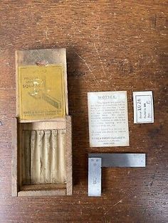 an old match box with matches and other items