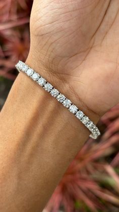 This is one of our most beloved and beautifully handcrafted lab diamond bracelet. This bracelet is studded with 9.42 carat Lab Diamonds that are round-cut. The bracelet is set in 10.95 grams 18K White Gold. The lab-grown diamonds used in this bracelet are created using advanced Chemical Vapor Deposition (CVD) technology, a process we proudly specialize in. These diamonds possess the same physical, chemical, and optical properties as diamonds, ensuring they sparkle with unparalleled brilliance and radiance. Each CVD diamond reflects light beautifully, creating a dazzling display that is indistinguishable from that of natural diamonds. This bracelet is a celebration of both beauty and ethical craftsmanship. Lab-grown diamonds offer a sustainable and environmentally friendly alternative to tr Luxury Platinum Diamond Bracelet With Brilliant Cut, Luxury Vvs Clarity Diamond Bracelet In Platinum, Platinum Diamond Cut Bracelet In Diamond White, Luxury Platinum Tennis Bracelet With Single Cut Diamonds, Luxury White Diamond Bracelet With Single Cut Diamonds, Luxury Diamond White Bracelet With Diamond Accents, Platinum Diamond Bracelet With Round Cut Accents, Luxury Diamond Bracelet With Brilliant Cut, Luxury White Diamond Bracelet With Brilliant Cut