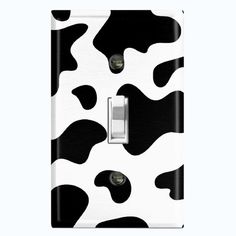 a black and white cow print light switch cover