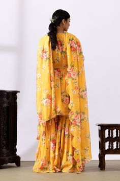 Mustard yellow gathered kurta with floral digital prints and lace detailing. Paired with printed gharara and dupatta.
Components: 3
Pattern: Printed
Type Of Work: Floral
Neckline: V neck
Sleeve Type: Three quarter
Fabric: Chanderi
Color: Yellow
Other Details: 
Lace detailing
Tassel tie-up
Tassel detailing on edge of dupatta
Scallop border
Occasion: Puja - Aza Fashions Designer Yellow Georgette Anarkali Set, Traditional Yellow Georgette Palazzo Set, Yellow Floor-length Salwar Kameez With Sheer Dupatta, Yellow Floor-length Georgette Anarkali Set, Yellow Anarkali Palazzo Set In Georgette, Yellow Anarkali Set In Georgette, Yellow Anarkali Floor-length Set, Yellow Sharara With Dupatta In Traditional Drape, Yellow Georgette Anarkali Set For Navratri