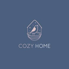 the logo for cozy home with a bird sitting in a bowl on top of it