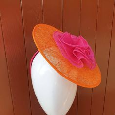 FREE UK Delivery Stunning orange sinamay disk fascinator covered with tangle weave sinamay fabric. It has a  beautifully handcrafted cerise pink sinamay flower. The fascinator is secured in place using an pink headband.  Please allow 7 working days for dispatch.  Thank you for looking Spring Orange Mini Hat For Wedding, Wedding Mini Hat In Orange With Adjustable Fit, Orange Mini Hat For Summer Wedding, Orange Mini Hat For Spring Wedding, Orange Mini Hats For Summer Weddings, Spring Wedding Orange Mini Hat, Orange Mini Hats For Spring Weddings, Adjustable Orange Mini Hats For Weddings, Adjustable Orange Mini Hat For Wedding