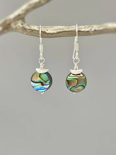 Handmade Abalone Dangle Earrings.   Iridescent abalone shell rounds are set in your choice of 14k gold fill, sterling silver, or rose gold fill and hang from your choice of leverbacks or French hook ear wires.   Simple, elegant earrings perfect summer or beach wedding earrings. The matching necklace is available for purchase separately in our store. Abalone drops are dainty - about 3/8" wide Overall Earring length - 1 1/4" long PLEASE note measurements and size reference pictures. Our jewelry an Elegant Nickel-free Shell Jewelry, Iridescent Round Jewelry With Ear Wire, Iridescent Mother Of Pearl Dangle Jewelry, Shell Dangle Jewelry For Gifts, Shell Dangle Jewelry Gift, Iridescent Mother Of Pearl Jewelry With Matching Earrings, Handmade Dangle Earrings With Abalone Shell, Iridescent Dangle Earrings From Abalone Shell, Iridescent Dangle Earrings With Abalone Shell