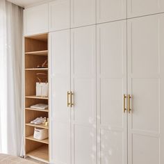 a bedroom with white closets and open doors