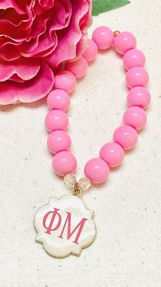 Wonderful Gift for all Phi Mu Sisters! A pink quatrefoil beaded bracelet monogrammed with Phi Mu written or Greek Letters in Hot Pink. 12mm Czech Opaque Glass Beads Round Pearl CoatedQuatrefoil Medal - (1" inch x 1" inch) Length 7" (inches) Shipping - $3.50 Flat FeePurchase Two or More Bracelets - Receive FREE Shipping Pink Polished Beaded Bracelets, Pink Polished Beads Bracelet, Personalized Pink Stretch Bracelet With Round Beads, Phi Mu Philanthropy Round, Phi Mu Gifts, Personalized Pink Round Beads, Phi Mu Tshirts, Phi Mu Crafts, Sorority Jewelry